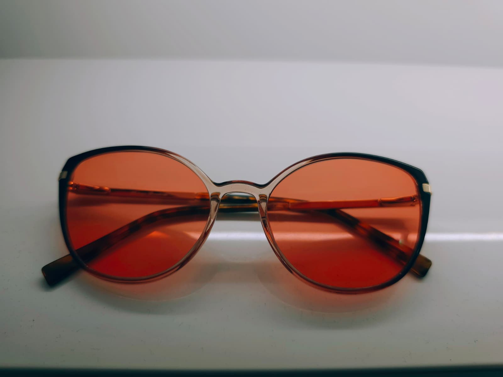 FL-41 migraine glasses Australia - woman wearing rose-tinted lenses